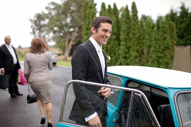 Groom with wedding car