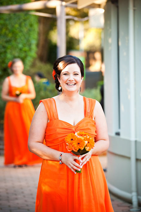 Walking down the aisle-orange bridesmaids