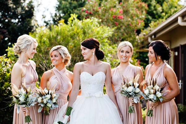 Bridesmaids wearing peach for rustic elegance themed wedding