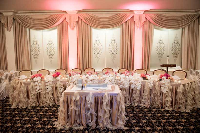 The bride used pink up-lights to create warmth by washing the walls