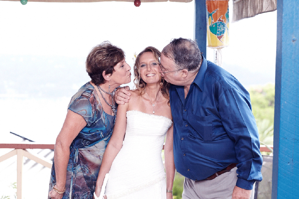 Bride in strapless gown with parents