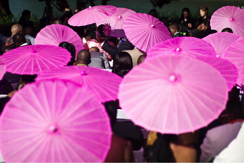 Pink parasols at wedding