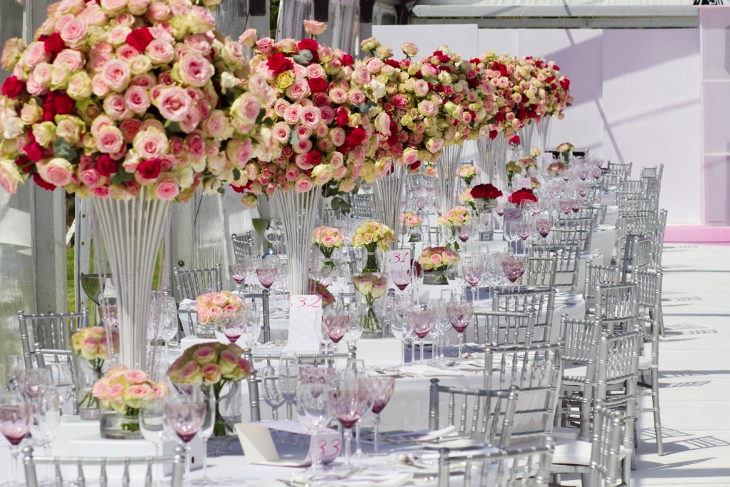 wedding table setup with masses of flowers