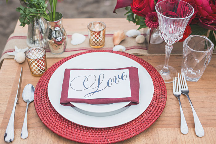Red beach wedding place setting