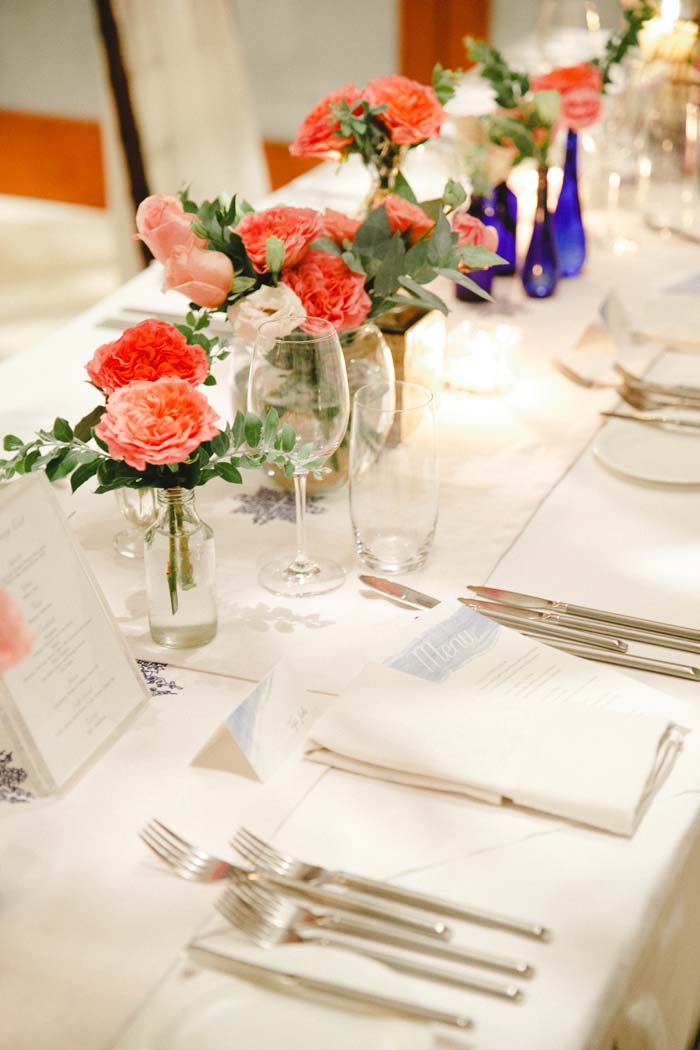 The table centerpiece in Coral David Austin, White Lisianthus, Eucalyptus and Pink Rose
