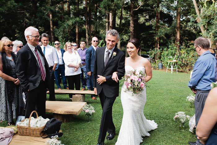 fater of the bride walks down aisle