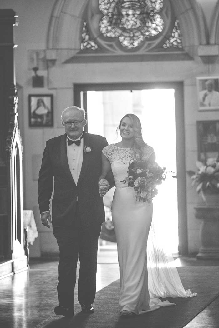 father of the bride and bride walking down the aisle
