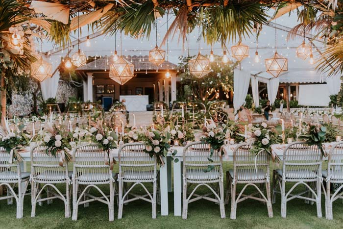 wedding reception tables with flowers and chandeliers