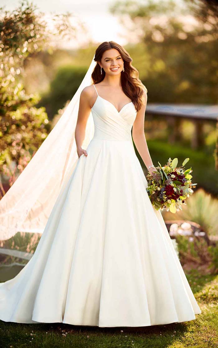 bride in classic dress holding flowers
