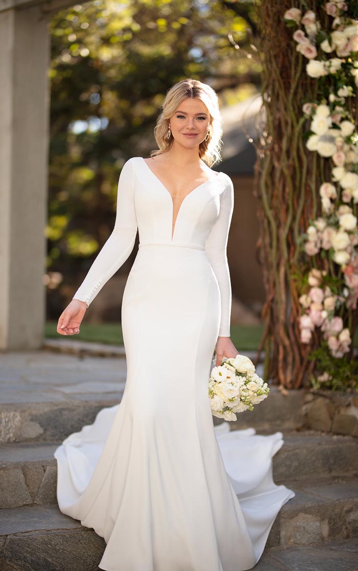 bride wearing long sleeved wedding dress with plunging neckline
